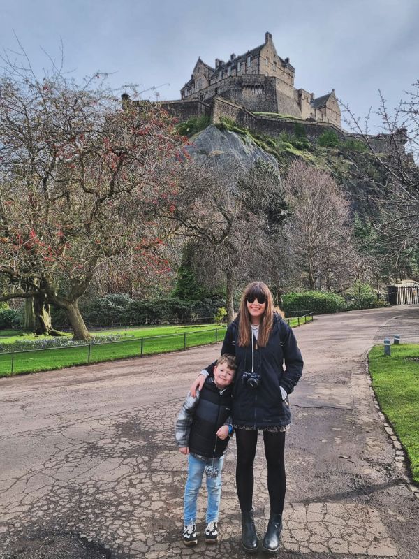 A mum and her son beneath Edinburgh Castle.