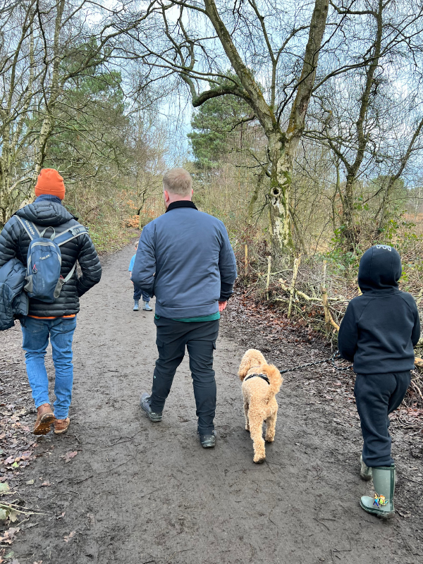 Royden Park friends walking a dog through the forest. Boys walking Arlo the dog in Royden Park.