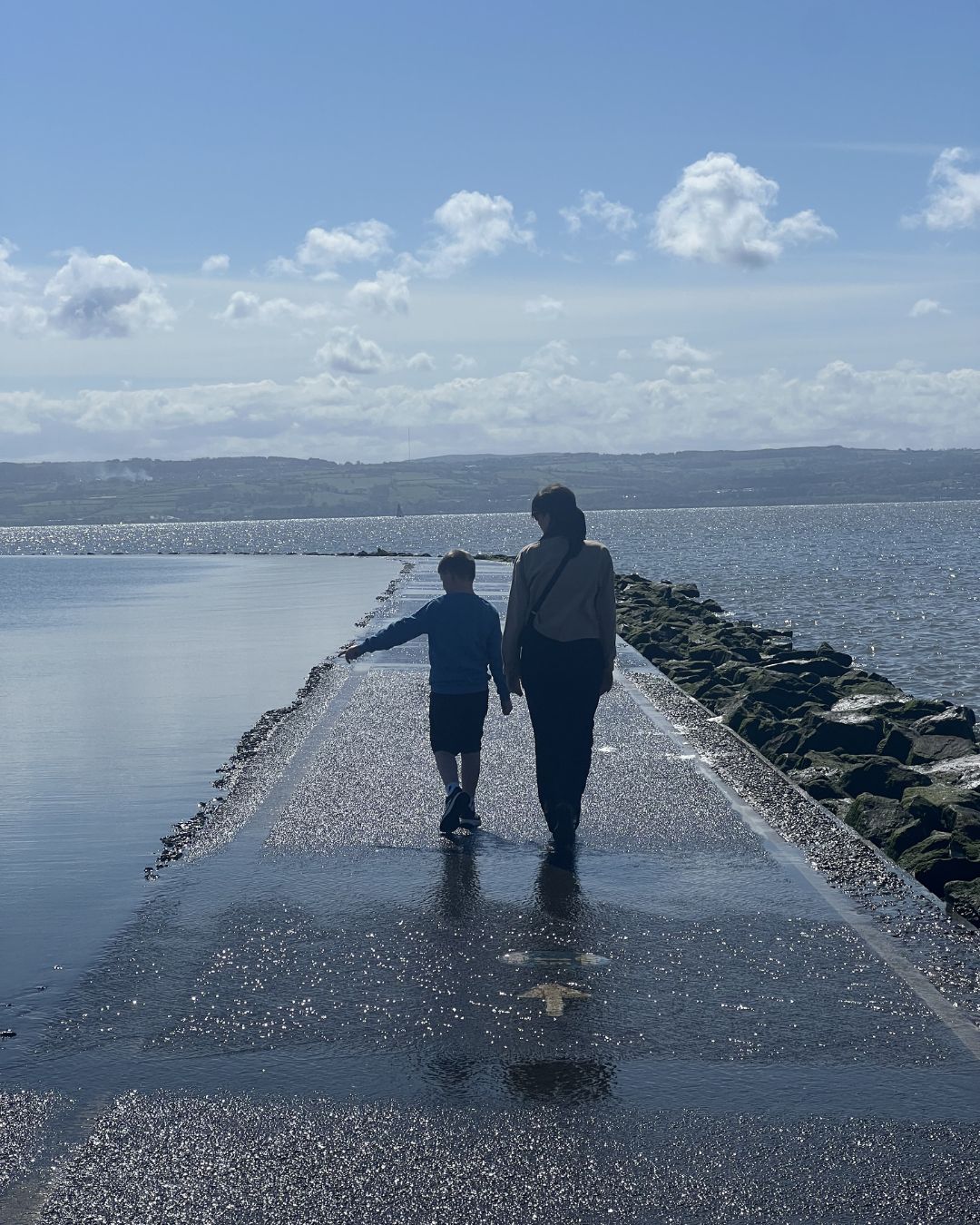 Mum and son walking around West Kirby Marine Lake. Mum and son walking around West Kirby Marine Lake.