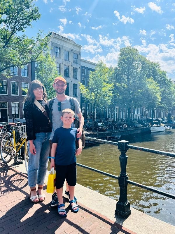 Family by a canal in Amsterdam on our interrailing with kids holiday.