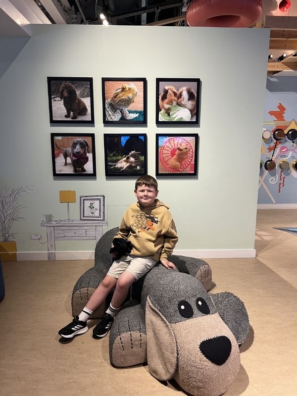 Eureka! Science and Discovery a little boy sitting on a giant dog.