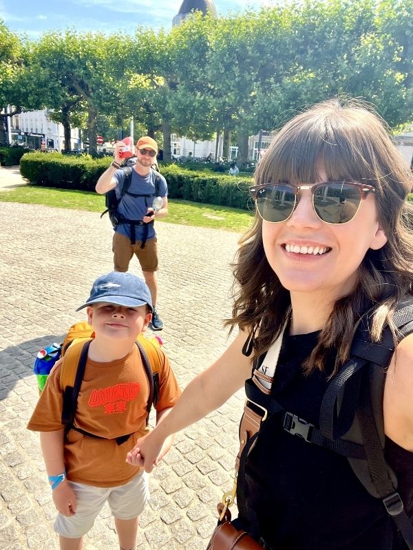 Family wearing backpacks in Europe on an interrailing trip.