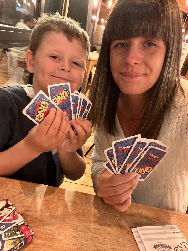 Mum and son playing uno cards.