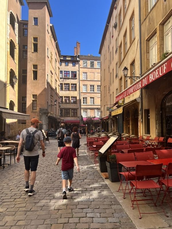Old town in Lyon, boys walking through the street.