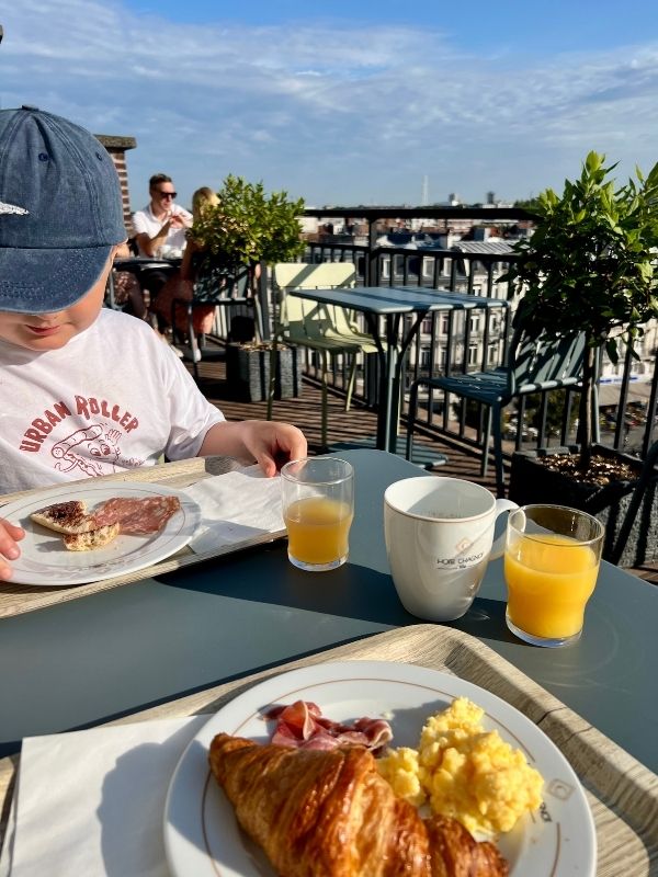 Rooftop terrace in our hotel while interrailing with kids in Lille, little boy having breakfast.